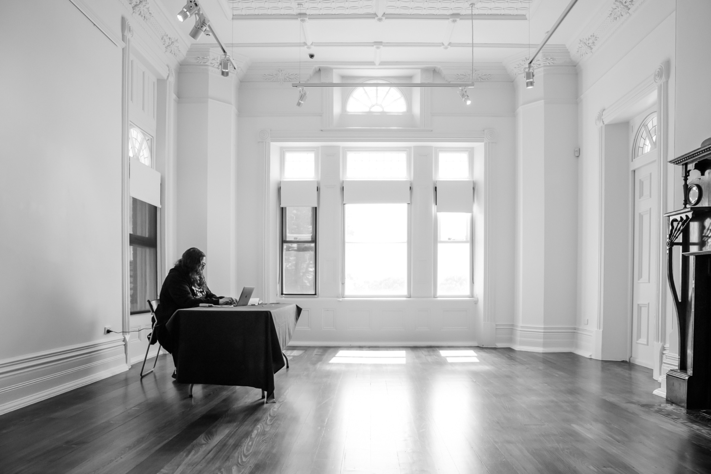 Claire G. Coleman writing at a table in Bundoora Homestead