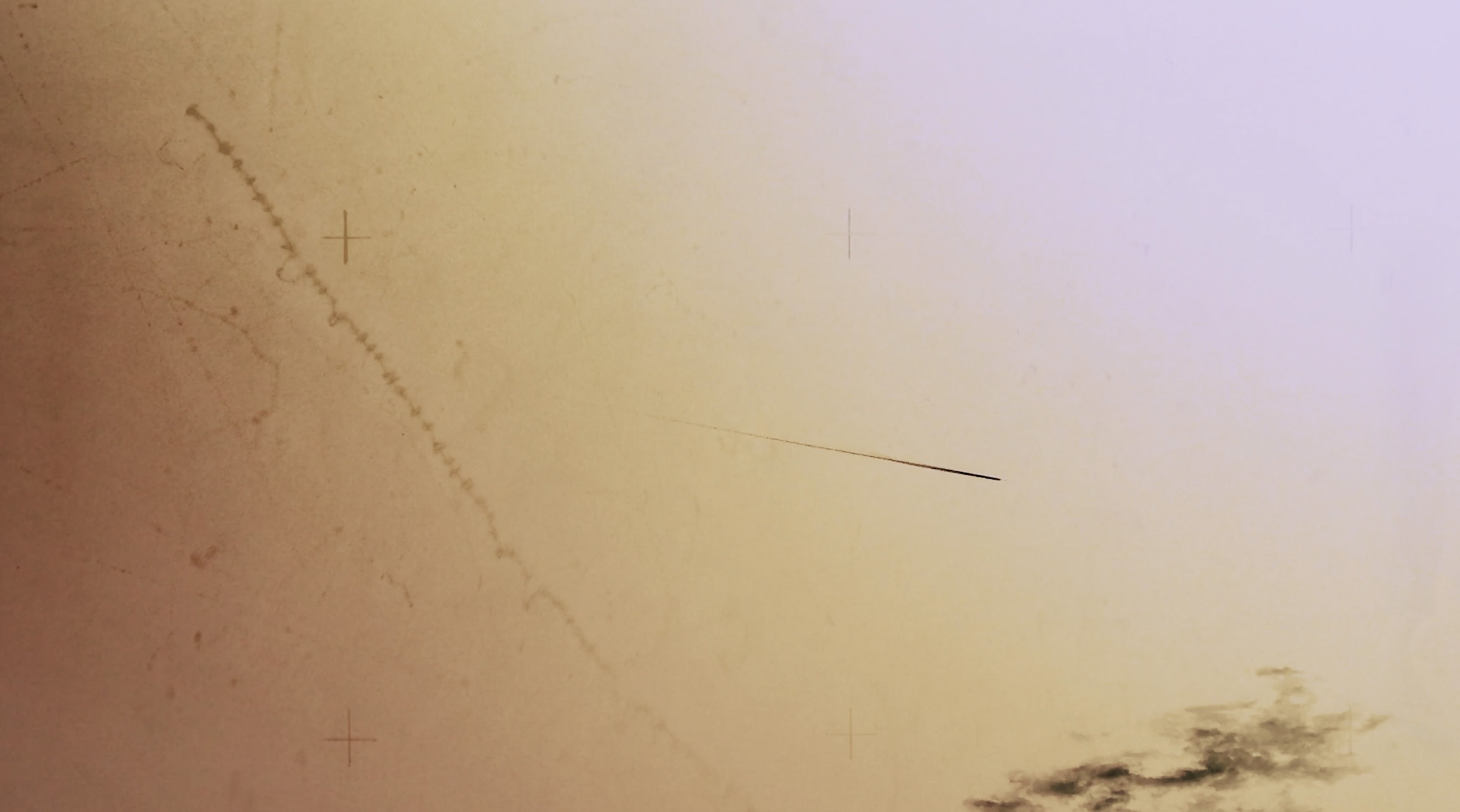 Still from Collider showing fine marks across a warm field of light