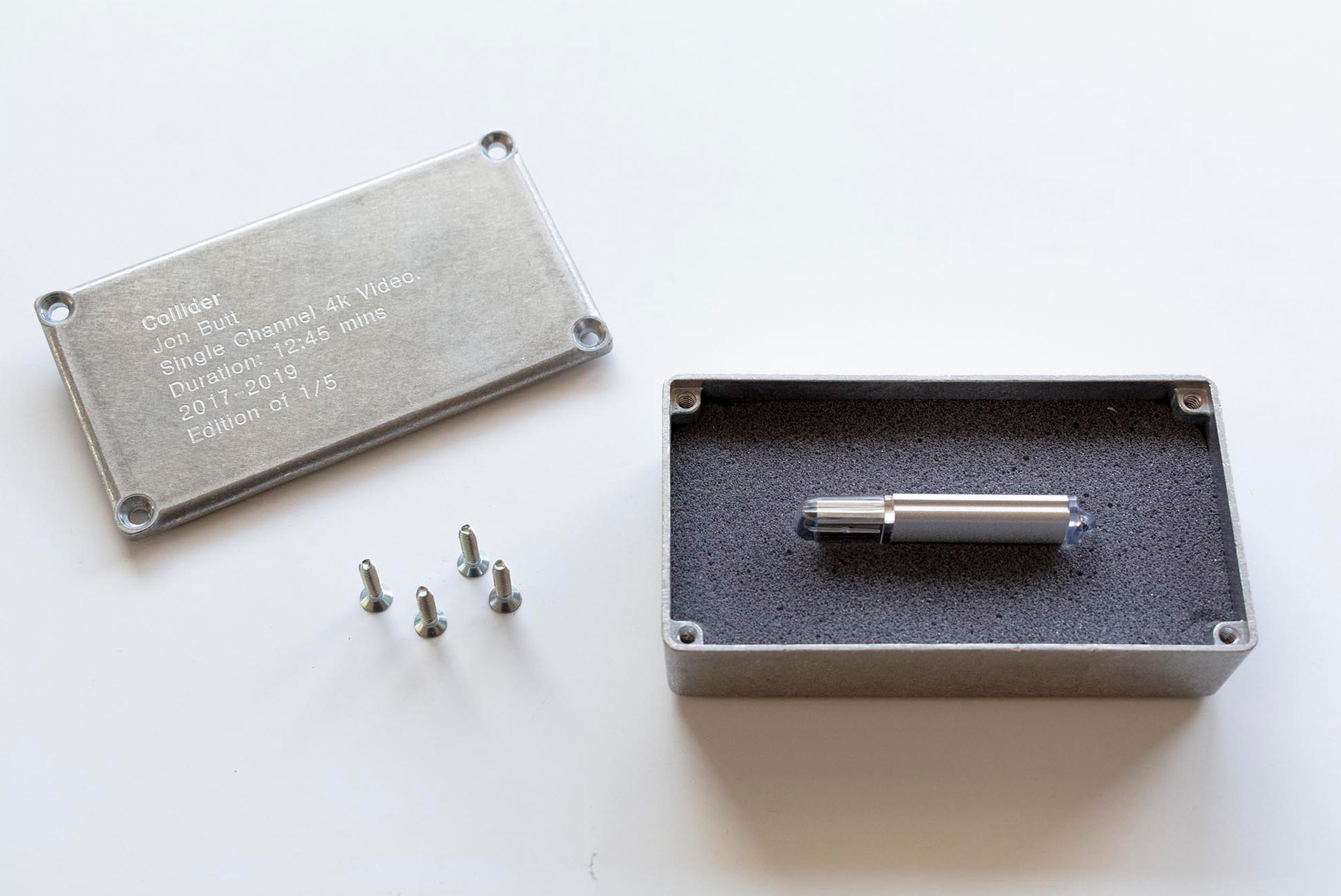Collider video edition presented as an engraved metal box containing a USB drive