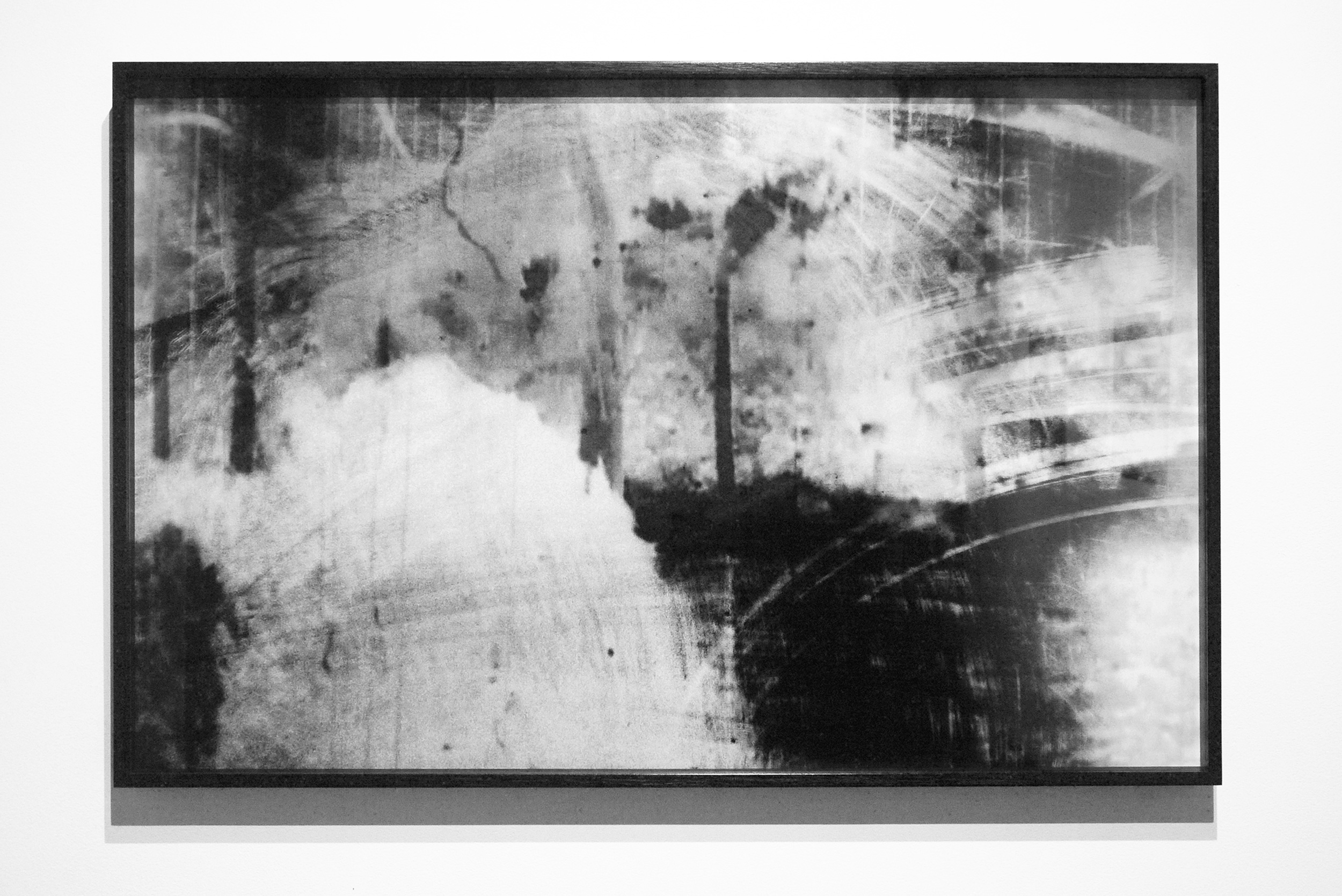 Black-and-white abstract photographic artwork in a dark frame