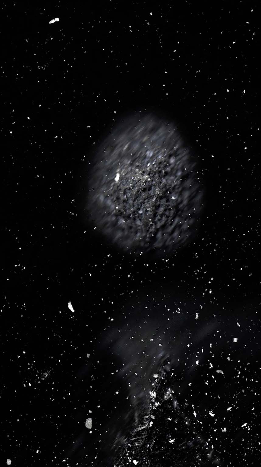 Dark Fieldcast video still with drifting mineral particles and blurred forms