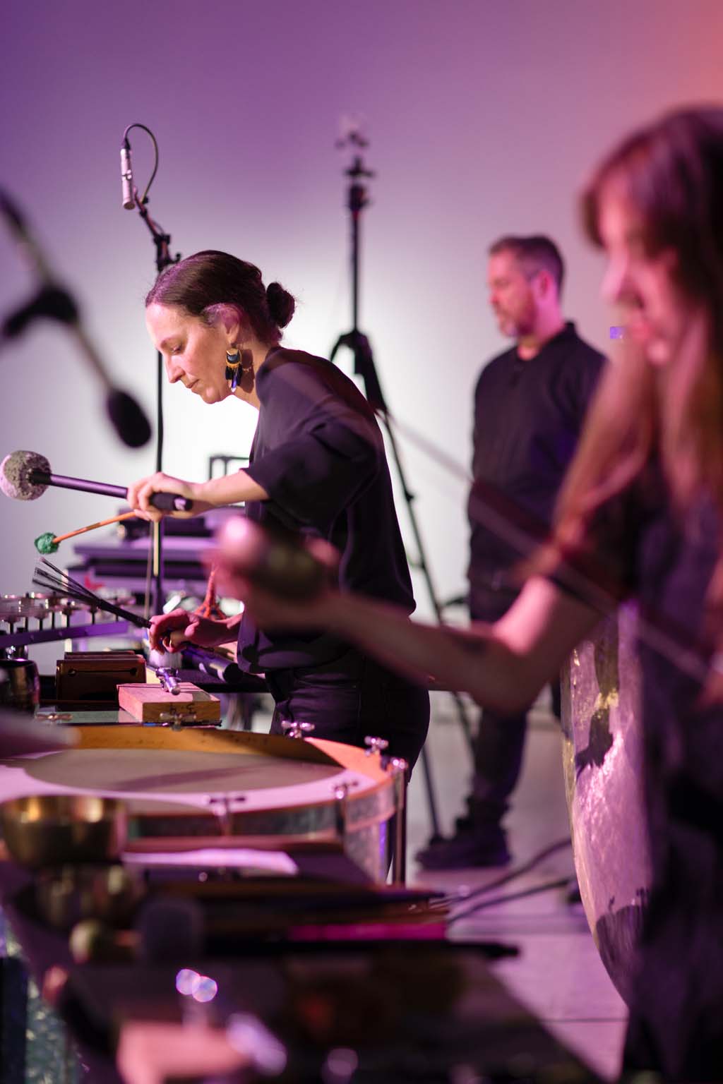 Kaylie Melville and Zela Papageorgiou performing in the foreground with Jon Butt behind them