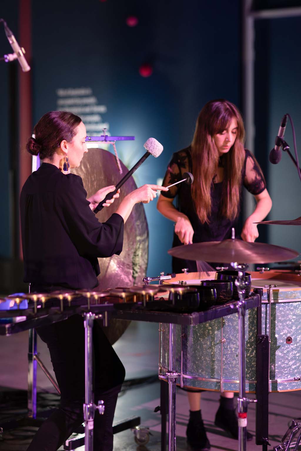 Kaylie Melville and Zela Papageorgiou performing together on drums, cymbals and metal percussion