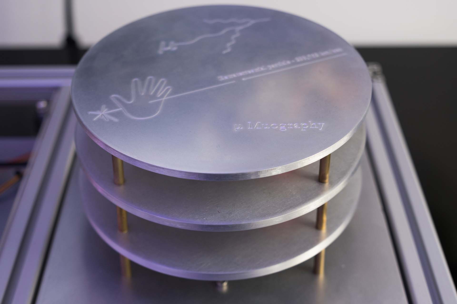 Detail of circular aluminium components engraved with μMuography imagery
